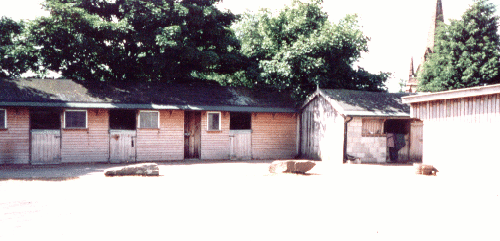One of the stable blocks with church in background